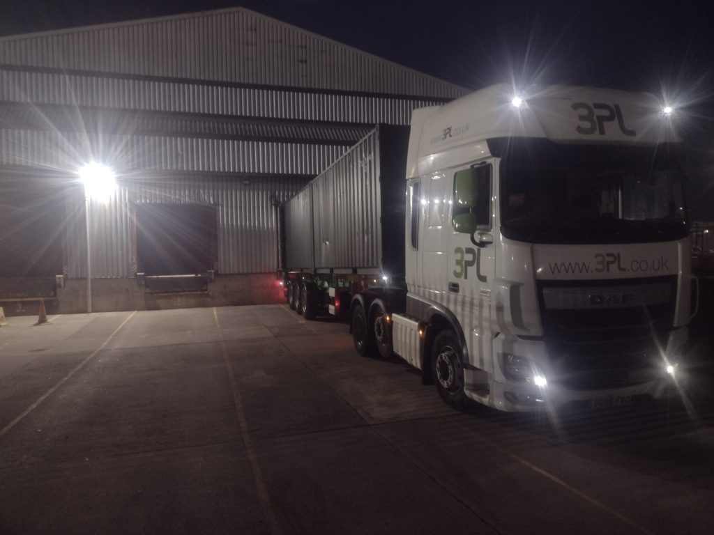 DAF super space cab loaded with containers, unloading at customer premises