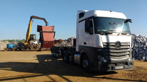 Mercedes Actros loading an export sea container with scrap